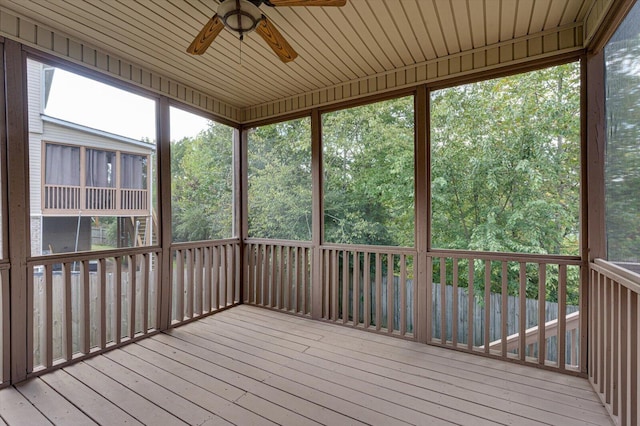 unfurnished sunroom featuring ceiling fan