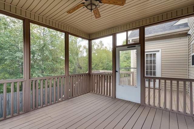 unfurnished sunroom featuring a wealth of natural light and ceiling fan