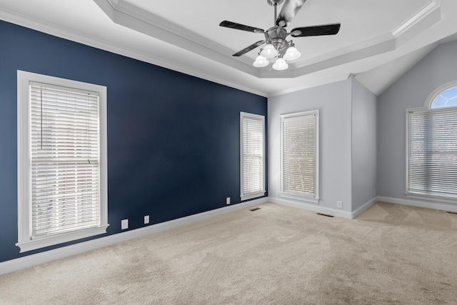 spare room featuring ceiling fan, light colored carpet, ornamental molding, and a tray ceiling