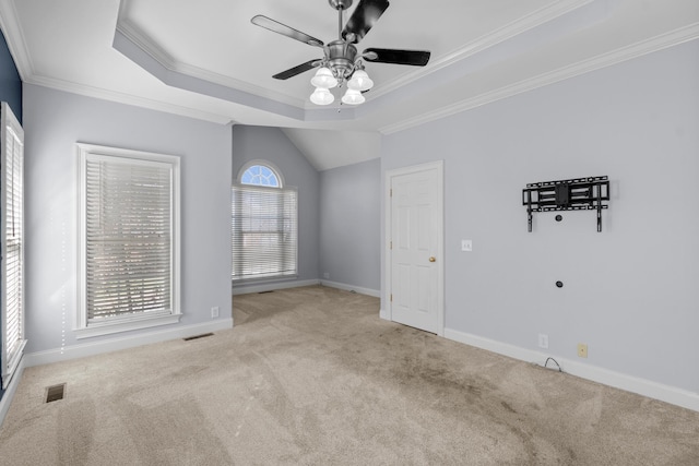 carpeted empty room featuring ornamental molding, ceiling fan, and a healthy amount of sunlight