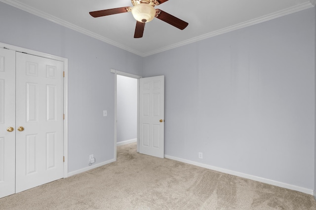 unfurnished bedroom with ceiling fan, light colored carpet, and ornamental molding