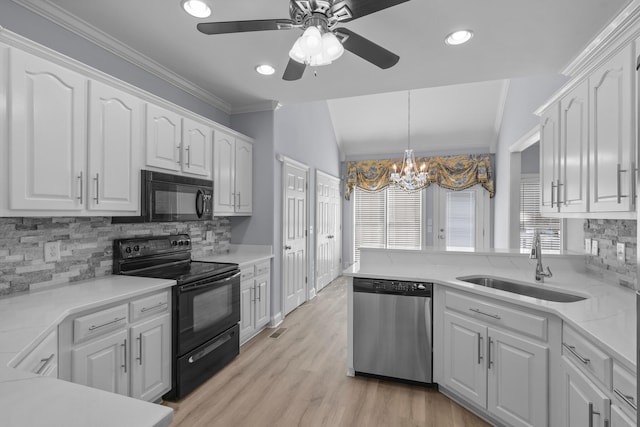 kitchen featuring white cabinets, black appliances, and lofted ceiling