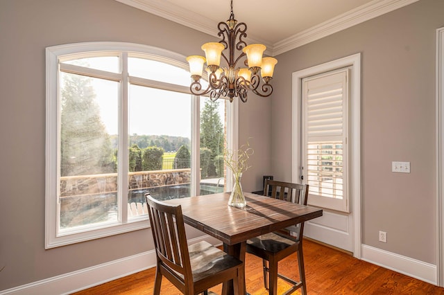 dining room featuring crown molding, a chandelier, and wood-type flooring