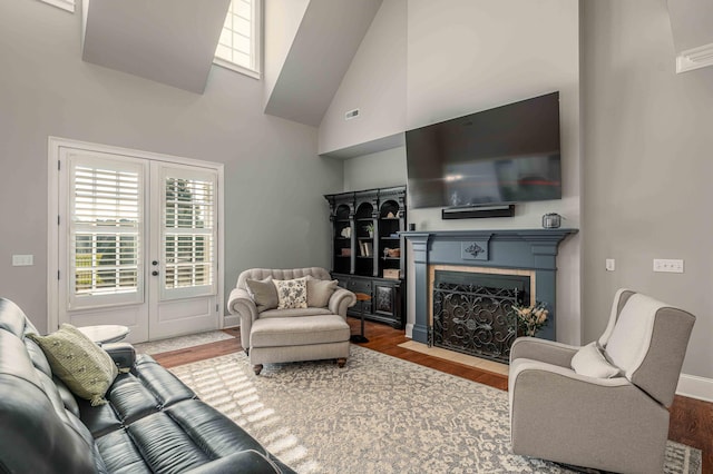 living room with wood-type flooring and a high ceiling