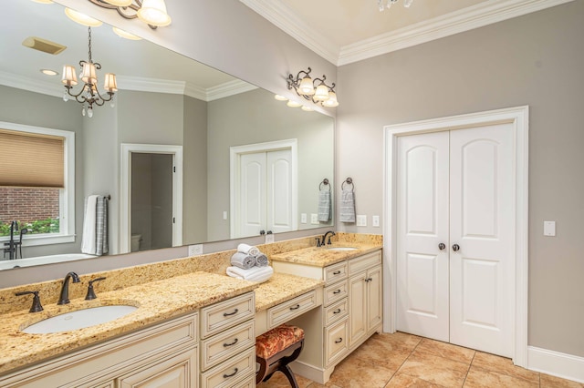 bathroom with tile patterned floors, vanity, ornamental molding, and a notable chandelier