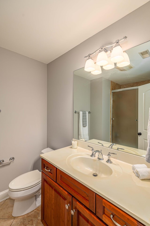 bathroom with tile patterned flooring, vanity, an enclosed shower, and toilet