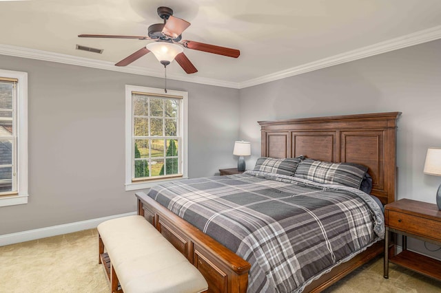 carpeted bedroom featuring ceiling fan and crown molding