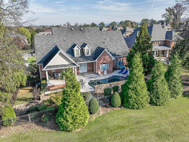 back of house featuring a fenced in pool, a yard, and a patio