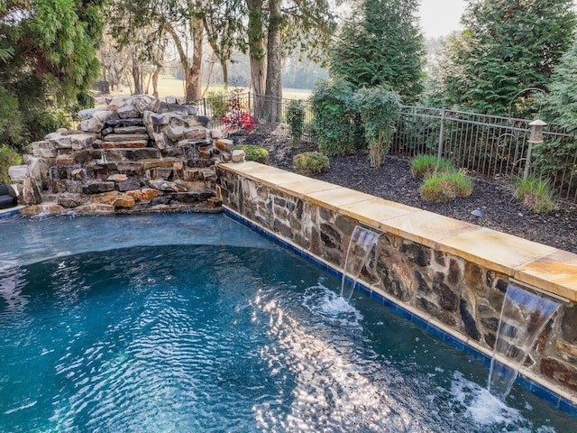 view of swimming pool featuring pool water feature