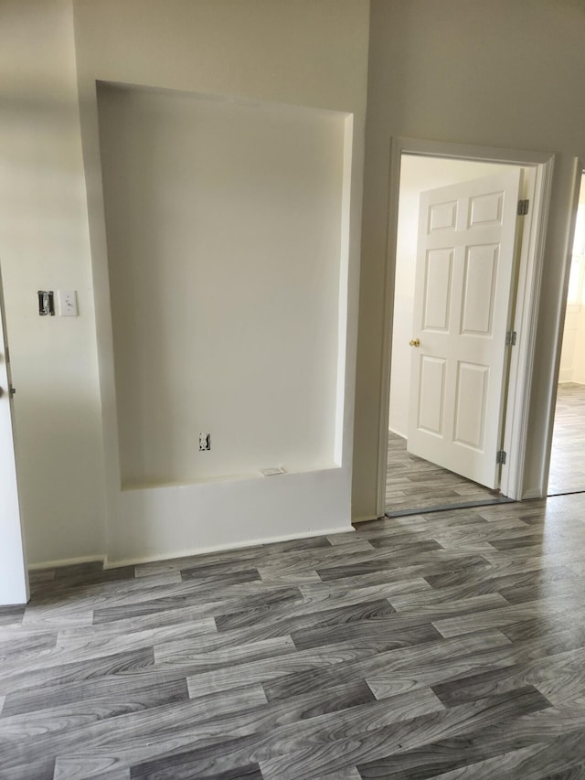 unfurnished room with dark wood-type flooring