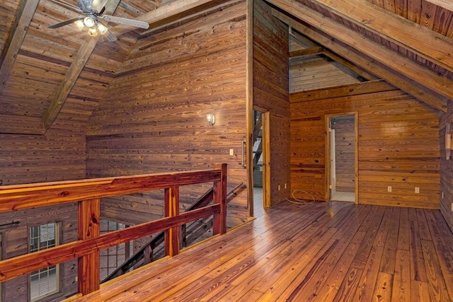 bonus room with hardwood / wood-style floors, ceiling fan, wooden ceiling, and wood walls