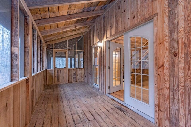 misc room featuring hardwood / wood-style floors, lofted ceiling with beams, wooden walls, and wooden ceiling