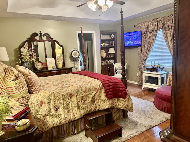 bedroom with ceiling fan and hardwood / wood-style flooring