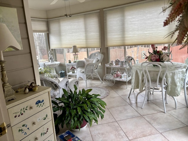 sunroom / solarium featuring ceiling fan