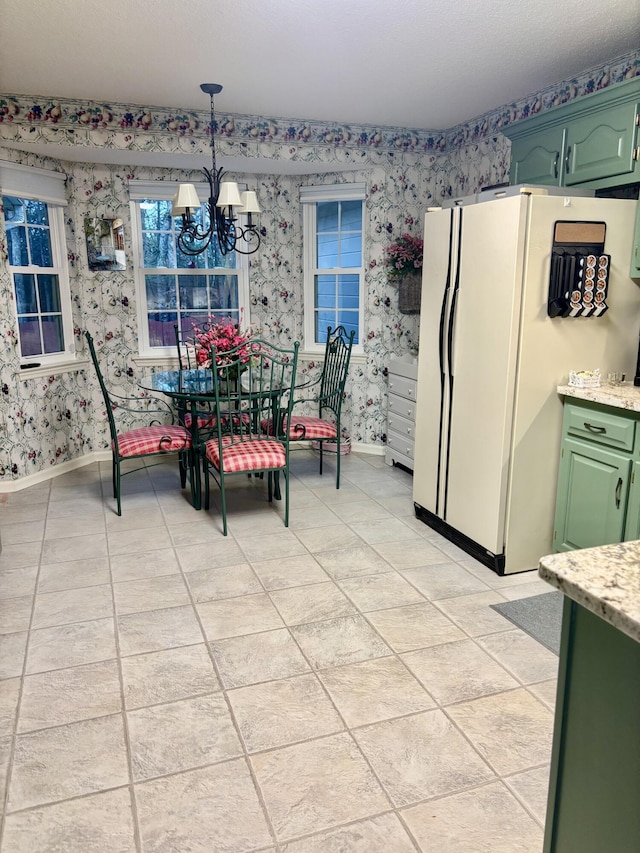 tiled dining area featuring a notable chandelier