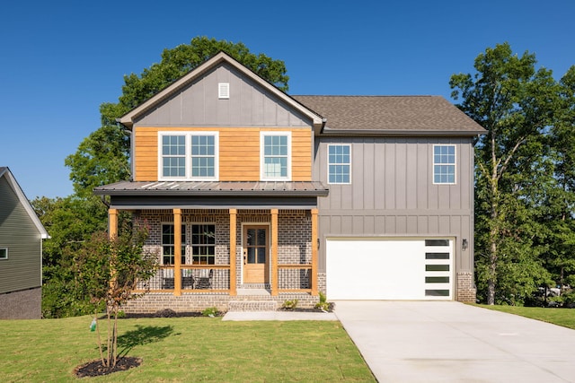 view of front of house featuring a garage, covered porch, and a front yard