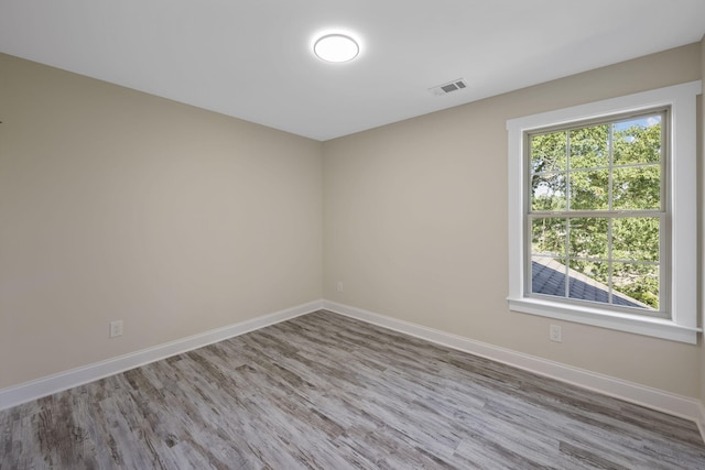 spare room featuring hardwood / wood-style floors