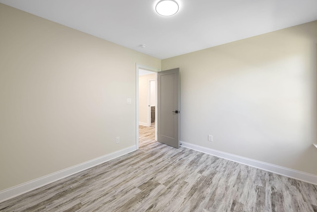 spare room with light hardwood / wood-style flooring