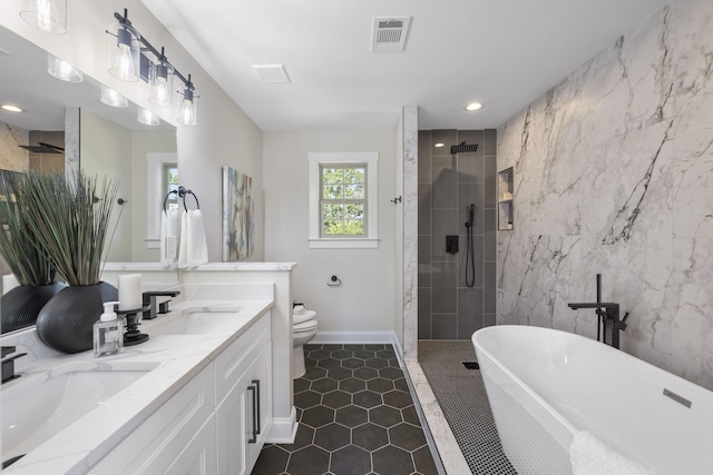 full bathroom featuring vanity, toilet, and independent shower and bath