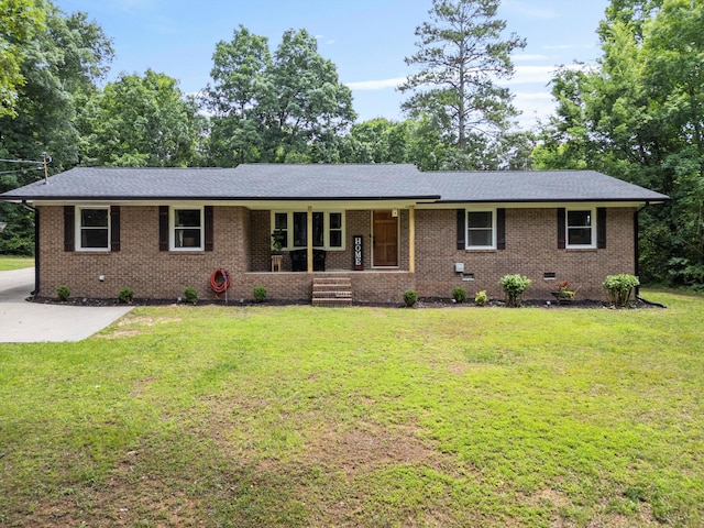 ranch-style home with covered porch and a front lawn