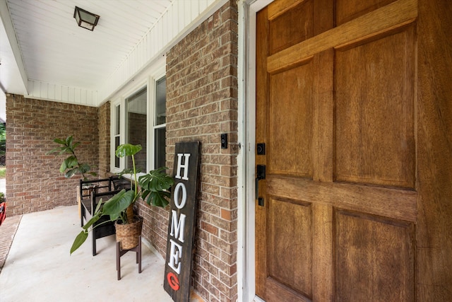 view of exterior entry featuring a porch