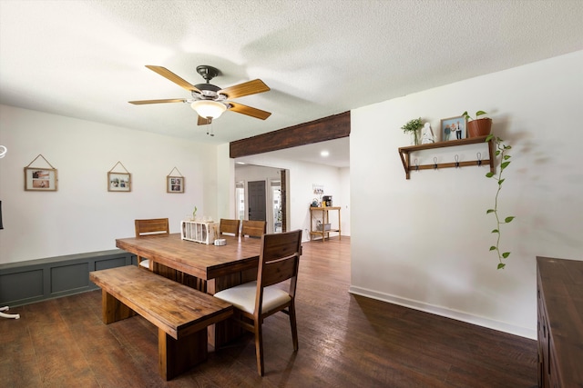 dining space with ceiling fan, dark wood-type flooring, and a textured ceiling