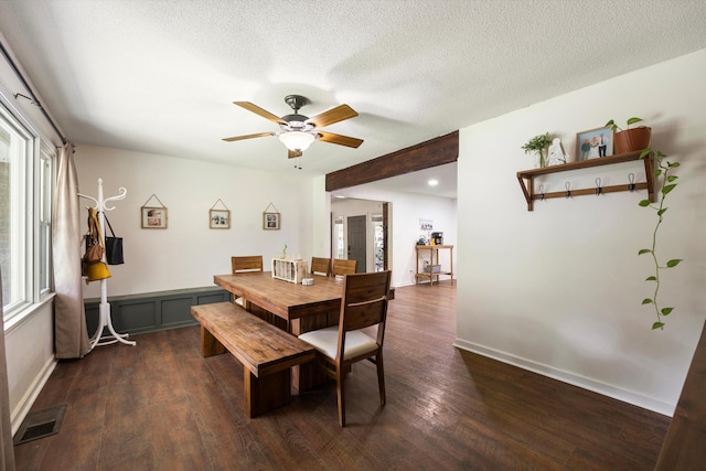 dining space with a wealth of natural light, ceiling fan, dark wood-type flooring, and a textured ceiling