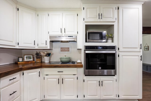 kitchen with butcher block countertops, white cabinetry, and stainless steel appliances