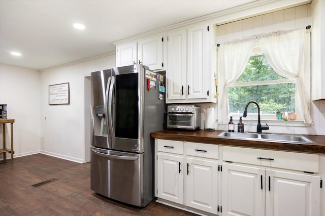 kitchen with white cabinetry, sink, dark wood-type flooring, stainless steel fridge with ice dispenser, and ornamental molding