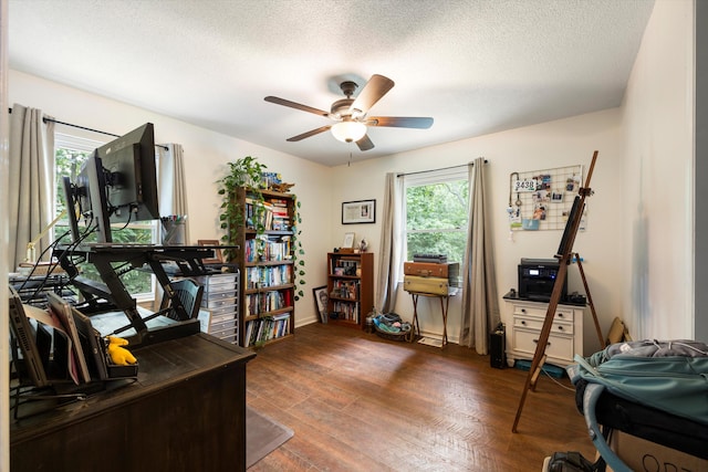 office area featuring a textured ceiling, ceiling fan, and dark wood-type flooring