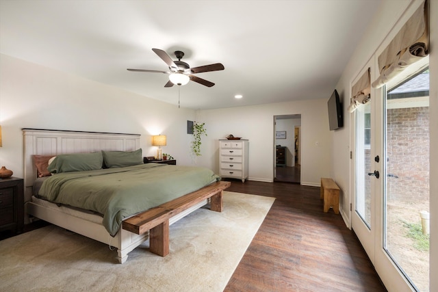 bedroom with ceiling fan, dark wood-type flooring, access to outside, and multiple windows