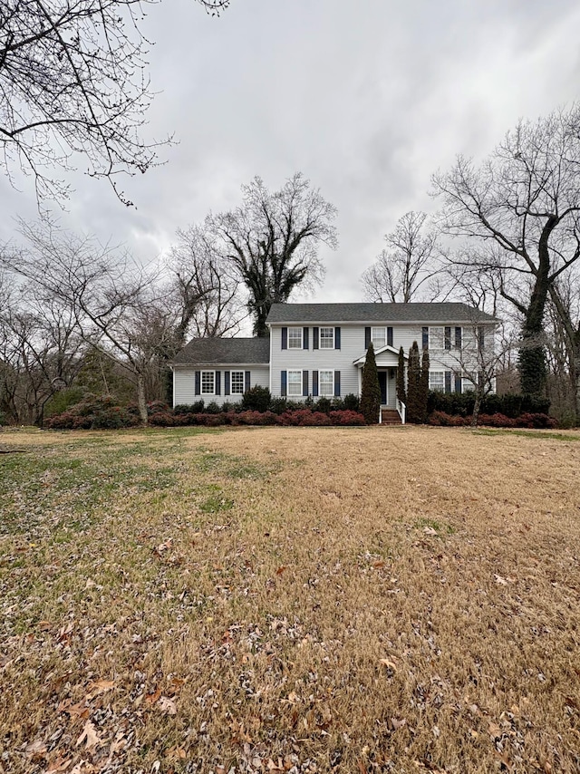 raised ranch with a front yard