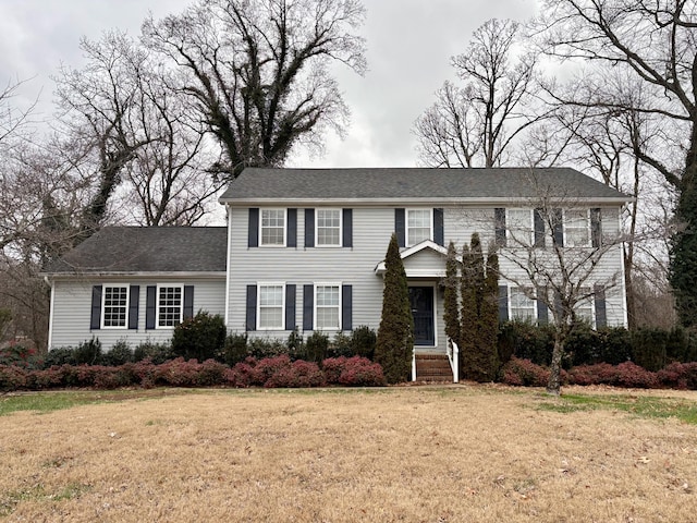 colonial inspired home with a front lawn