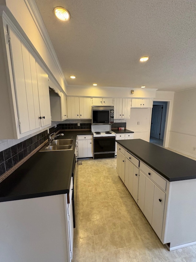 kitchen with decorative backsplash, white cabinetry, white range with electric stovetop, and sink