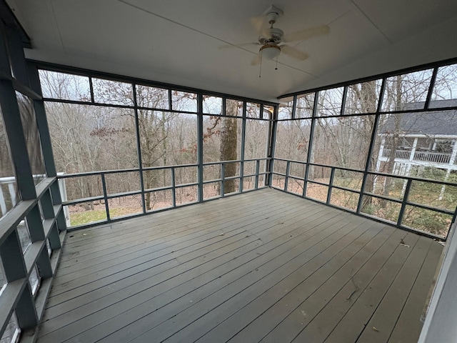 unfurnished sunroom featuring ceiling fan