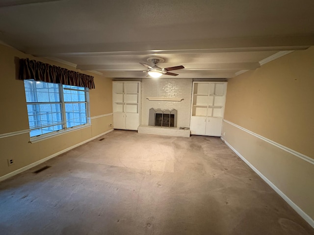 unfurnished living room with beamed ceiling, ceiling fan, and a fireplace