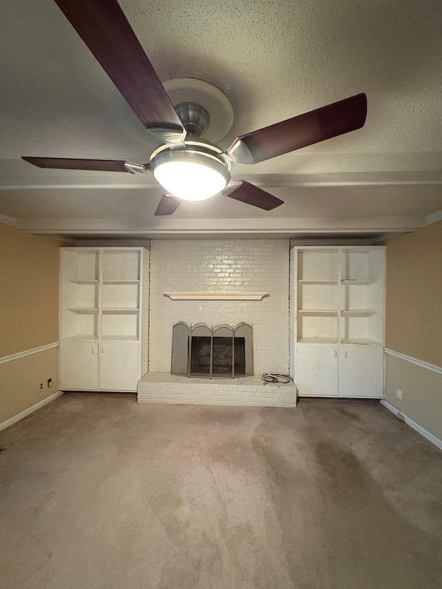 unfurnished living room with built in shelves, carpet floors, and a brick fireplace