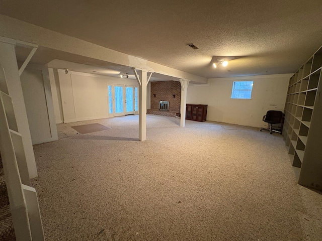 basement with carpet and a textured ceiling