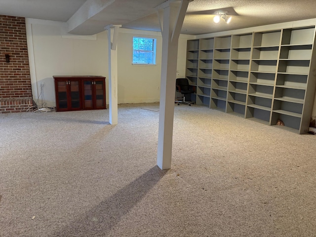 basement with carpet flooring and a textured ceiling