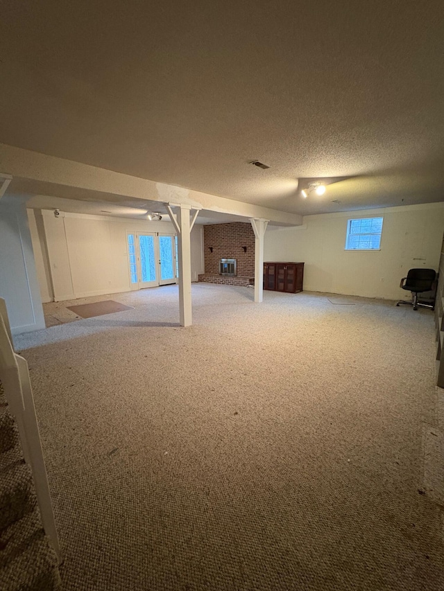 basement with carpet floors and a textured ceiling