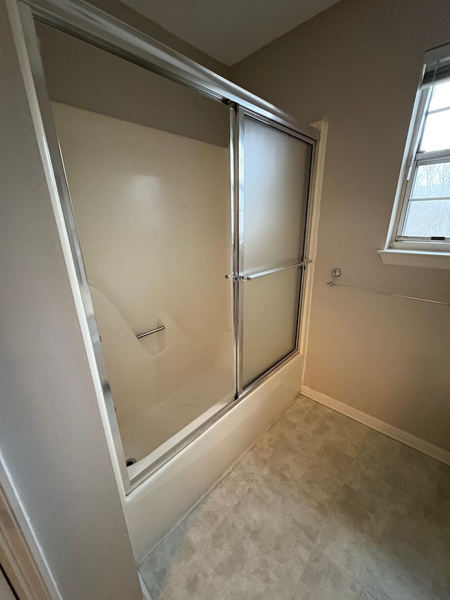 bathroom featuring shower / bath combination with glass door