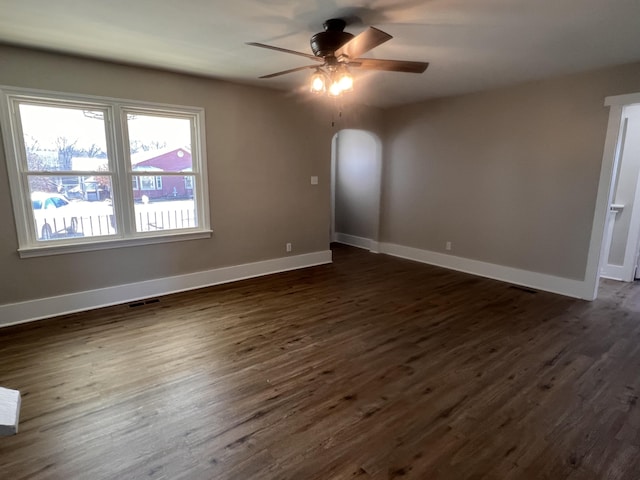 unfurnished room featuring dark hardwood / wood-style floors and ceiling fan