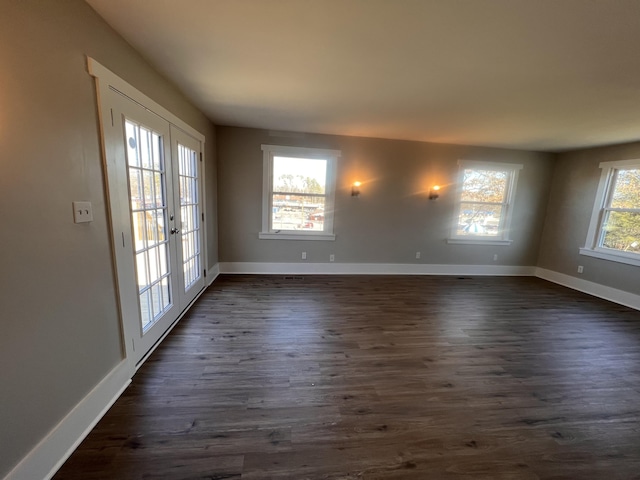 empty room featuring dark hardwood / wood-style flooring and french doors