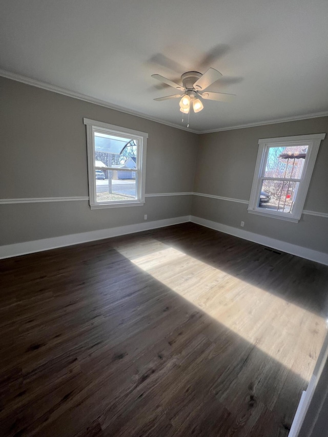 empty room with crown molding, dark hardwood / wood-style floors, and ceiling fan