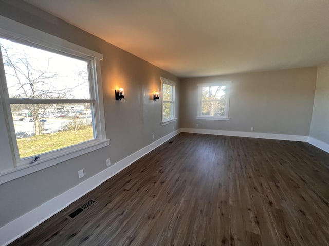 spare room featuring dark wood-type flooring