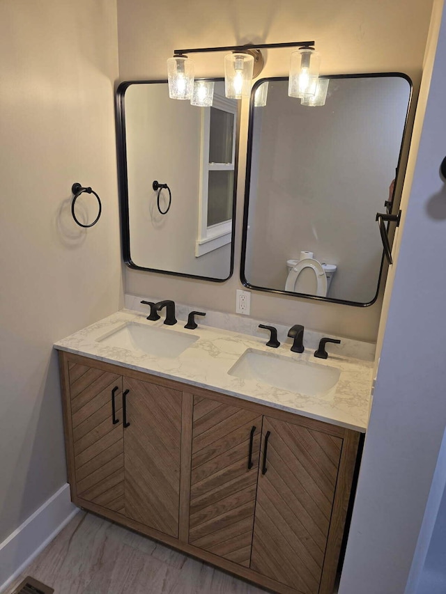 bathroom with vanity and toilet