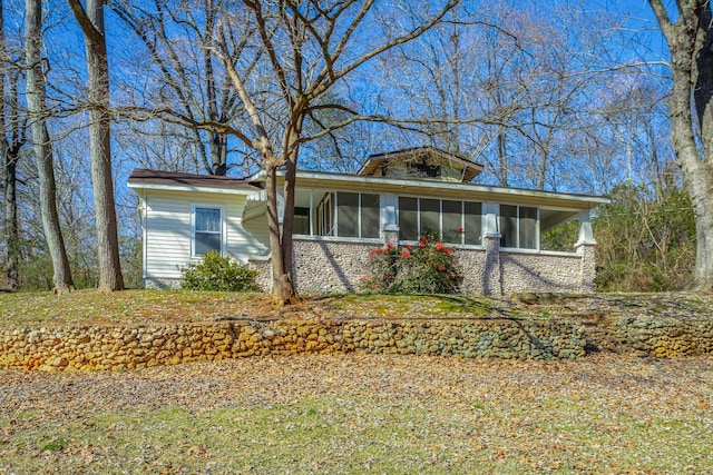 view of front of home with a sunroom