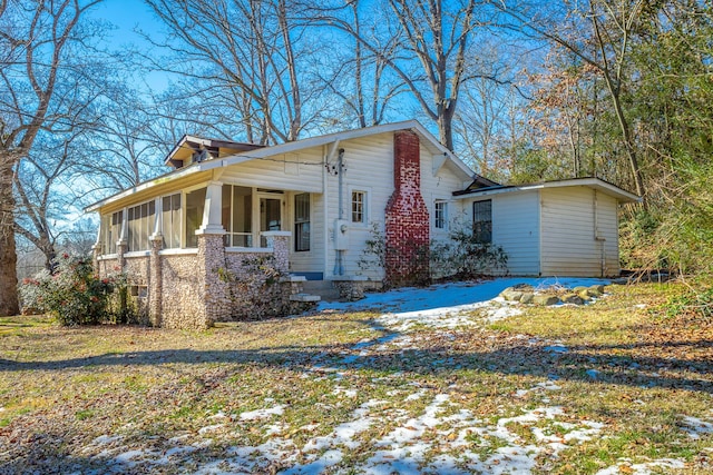 view of front facade with a porch and a sunroom