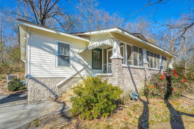 view of side of home with a sunroom