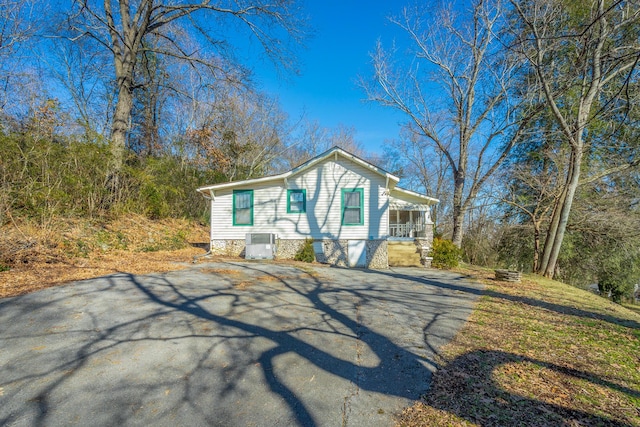 view of front of property featuring a porch and cooling unit